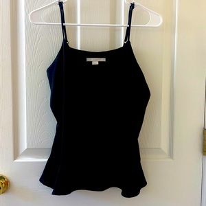 Women’s dressy tank with adjustable spaghetti straps and ruffled bottom edge